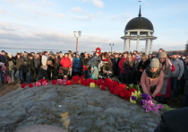 Цветы и горящие свечи к импровизированному поминальному камню на петрозаводской набережной несли как первые лица города и республики, так и простые горожане