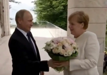 Западная пресса раскритиковала Владимира Путина за то, что он преподнес букет цветов канцлеру ФРГ Ангеле Меркель