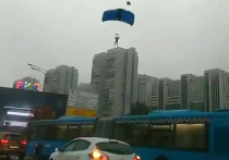 Автомобилисты, которые стояли утром в четверг, 23 сентября, в пробке на Ленинском проспекте, смогли насладиться необычным зрелищем: с высотного здания спрыгнули несколько парашютистов