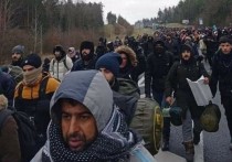 Группа мигрантов перебралась через колючую проволоку, установленную белорусскими пограничниками на контрольно-пропускном пункте на границе с Польшей