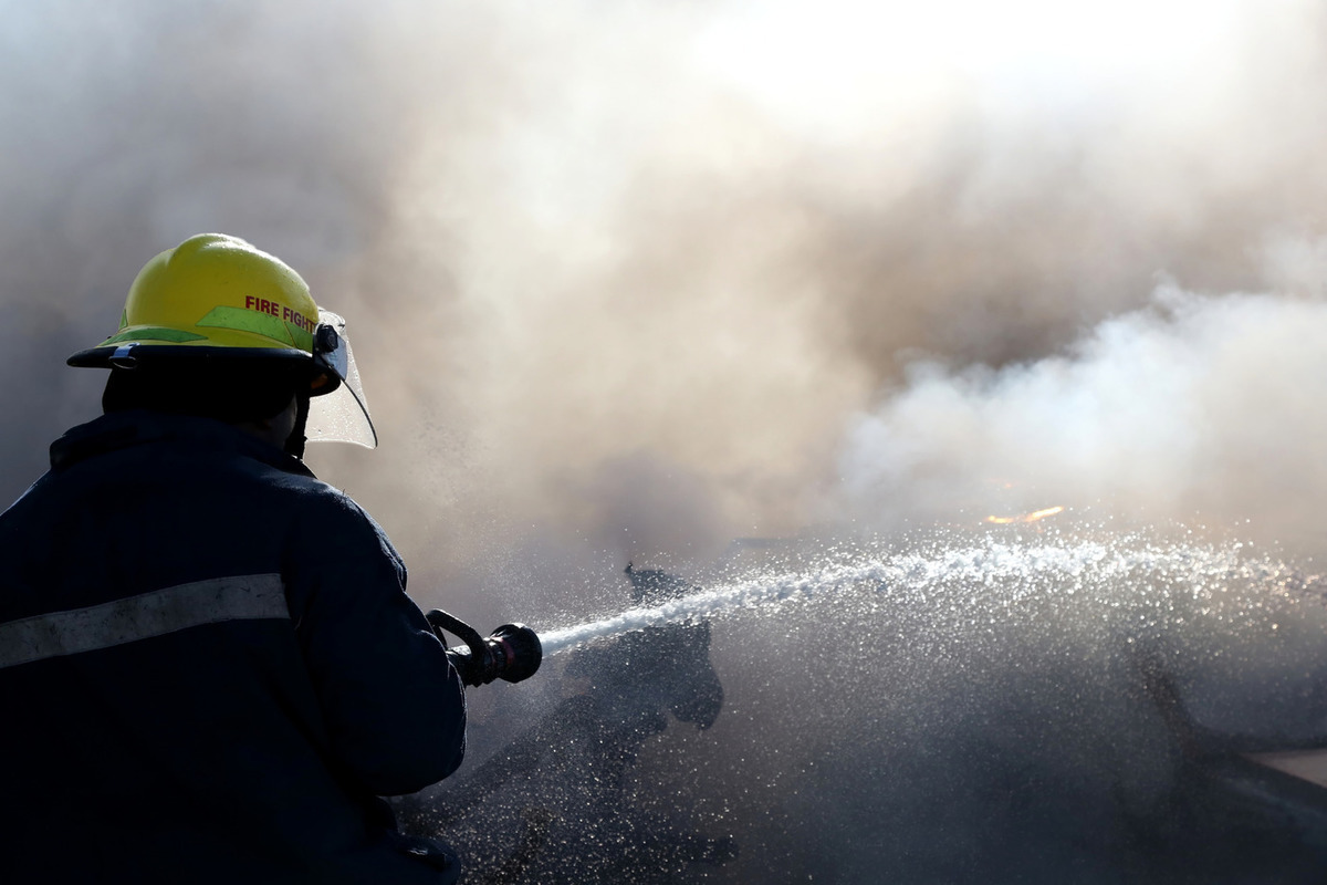 Putting on fire. Пожар на предприятии. Firefighters putting out Fire. Распыление воды при пожаре. Пожар предприятий черно белое фото.