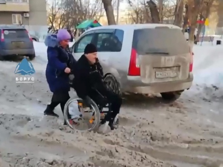 Инвалид на коляске увяз в снежном месиве на улице Щорса в Красноярске