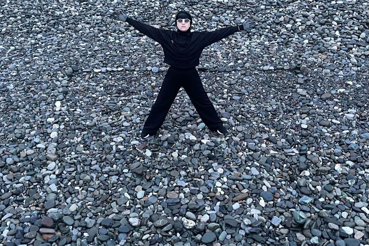 Participants in the performance drew a “Black Square” with their bodies on the seashore