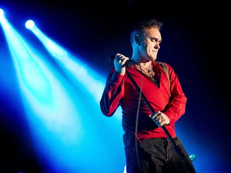 Morrissey performing live, deep in thought